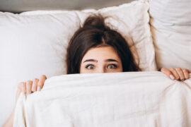 Model,Woman,Hiding,Under,The,Blanket.,Young,Woman,Is,Very