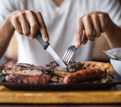 Man,Eating,Grilled,Meats