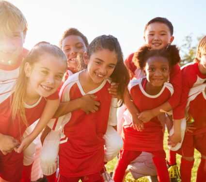 Kids,In,Elementary,School,Sports,Team,Piggybacking,Outdoors