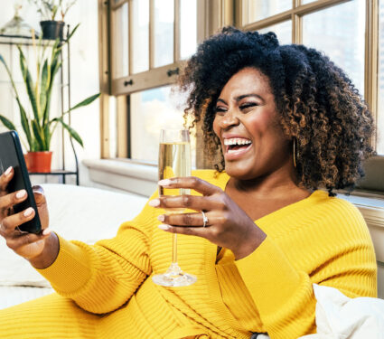 Portrait,Of,A,Happy,Smiling,Woman,Laughing,While,Celebrating,And