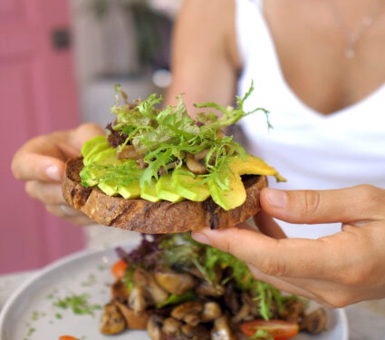 Young,Caucasian,Woman,Eating,Healthy,Vegan,Avocado,Toast,With,Great