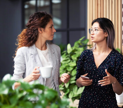 Diverse,Employees,Chatting,During,Coffee,Break,,Walking,In,Modern,Office,