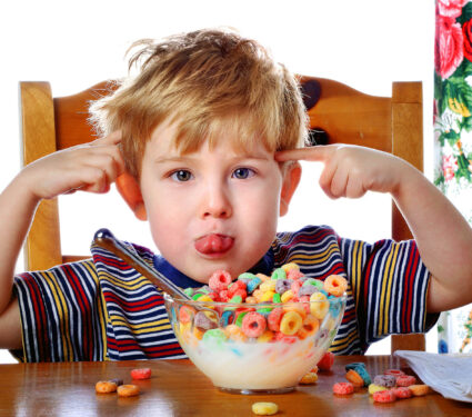 Boy,Misbehaving,While,Eating,Breakfast,Cereal