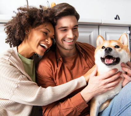 Cheerful,Man,Cuddling,Shiba,Inu,Dog,Near,Smiling,African,American