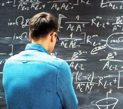 Brilliant,Young,Mathematician,Approaches,Big,Blackboard,And,Thinking,About,Sophisticated