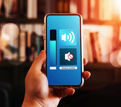 Close-up,View,Of,Hand,Turning,Down,The,Volume,Of,Smartphone