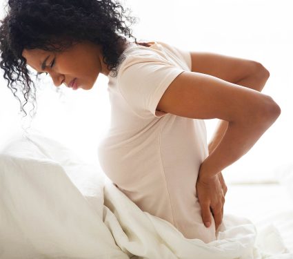 Sad,Young,African,Woman,Touching,Back,Feeling,Backache,Morning,Discomfort