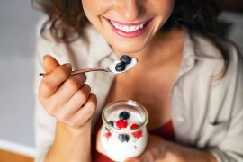 Close,Up,Of,Of,Smiling,Woman,Having,A,Healthy,Breakfast